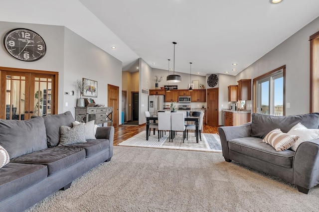 living area featuring recessed lighting, french doors, and high vaulted ceiling