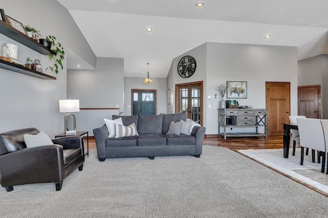 living room with recessed lighting, french doors, high vaulted ceiling, and wood finished floors