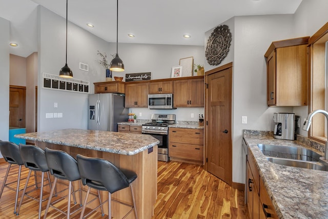 kitchen with a sink, visible vents, brown cabinets, and appliances with stainless steel finishes