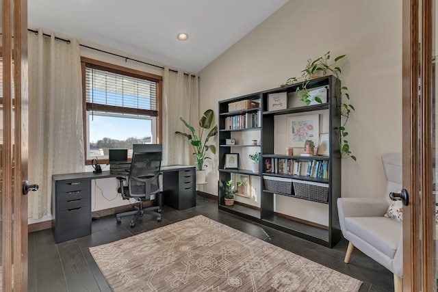 office space featuring lofted ceiling, baseboards, and dark wood-style flooring