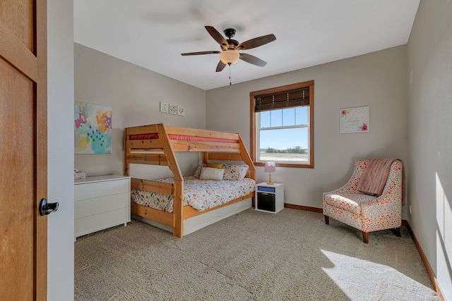 carpeted bedroom featuring baseboards and a ceiling fan