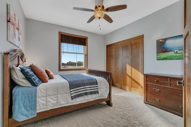 bedroom with a ceiling fan, light colored carpet, and a closet