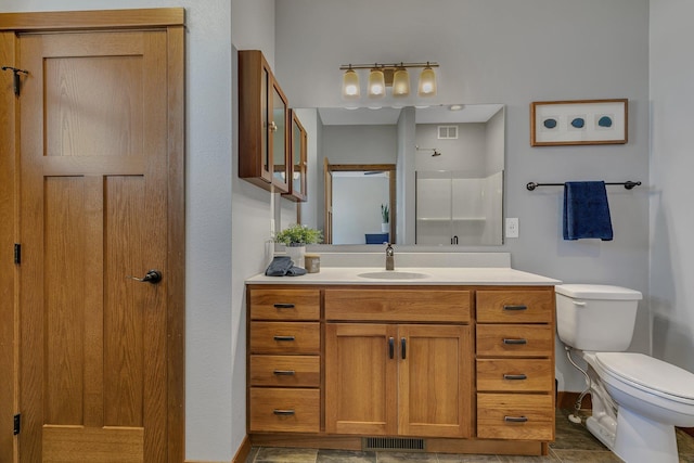 bathroom featuring visible vents, toilet, vanity, and baseboards