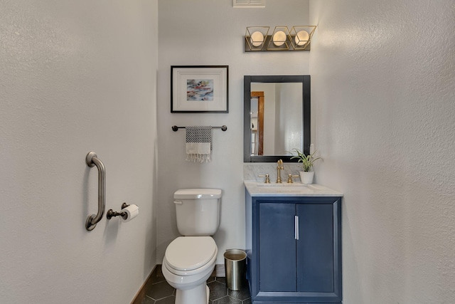 bathroom featuring tile patterned flooring, visible vents, baseboards, toilet, and vanity