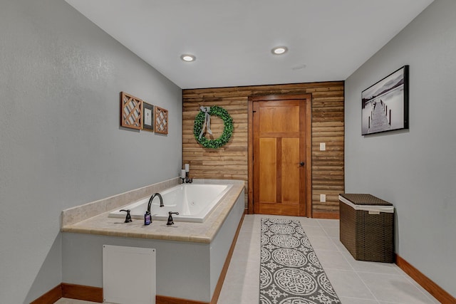 full bathroom with a tub with jets, baseboards, recessed lighting, tile patterned flooring, and wood walls