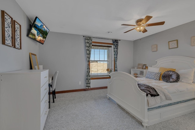 bedroom with light colored carpet, baseboards, and ceiling fan