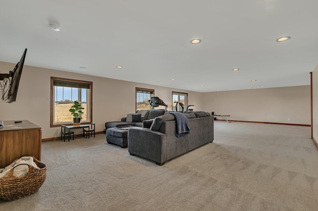 living area with light carpet, recessed lighting, and baseboards