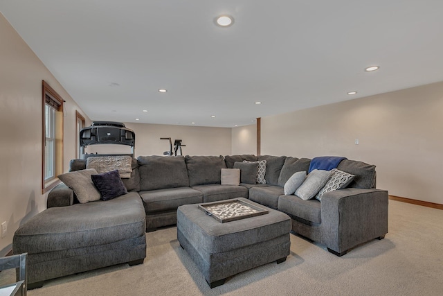 living area featuring recessed lighting, light colored carpet, and baseboards