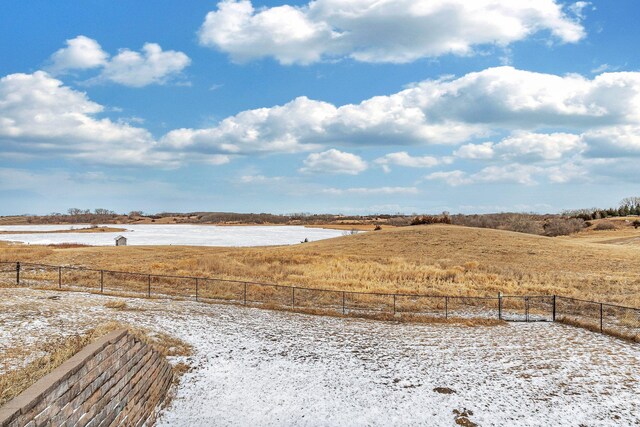 view of yard featuring fence and a water view