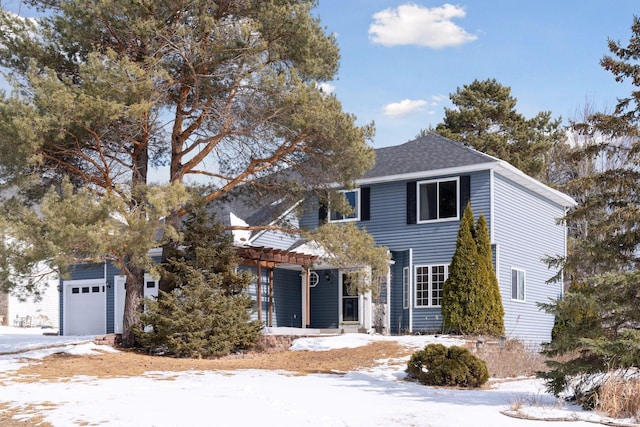 view of front facade featuring a garage, a pergola, and a shingled roof