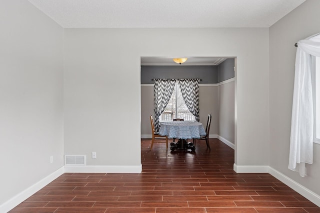 unfurnished dining area featuring visible vents, baseboards, and wood tiled floor