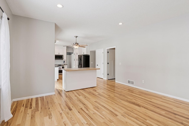 unfurnished living room featuring recessed lighting, visible vents, baseboards, and light wood-style floors