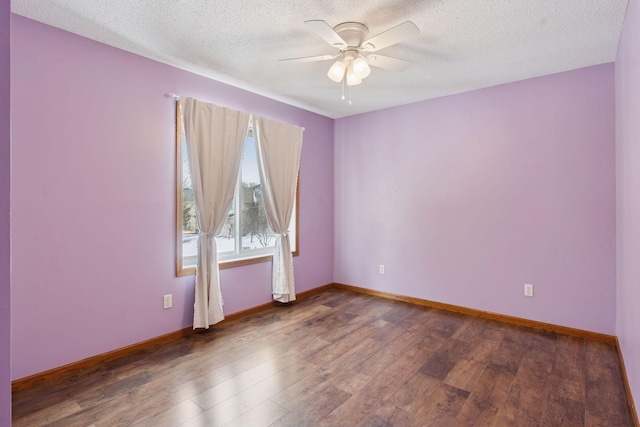 empty room featuring ceiling fan, wood finished floors, baseboards, and a textured ceiling