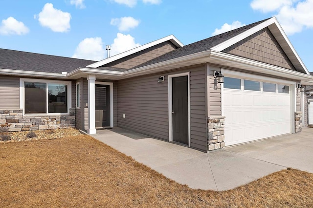 view of front facade with stone siding and an attached garage