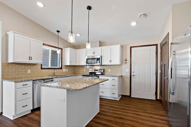 kitchen with stainless steel appliances, visible vents, white cabinets, vaulted ceiling, and a sink