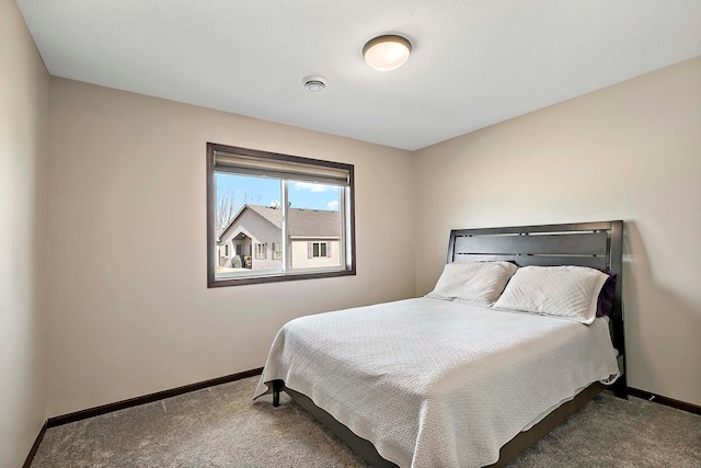 carpeted bedroom featuring baseboards