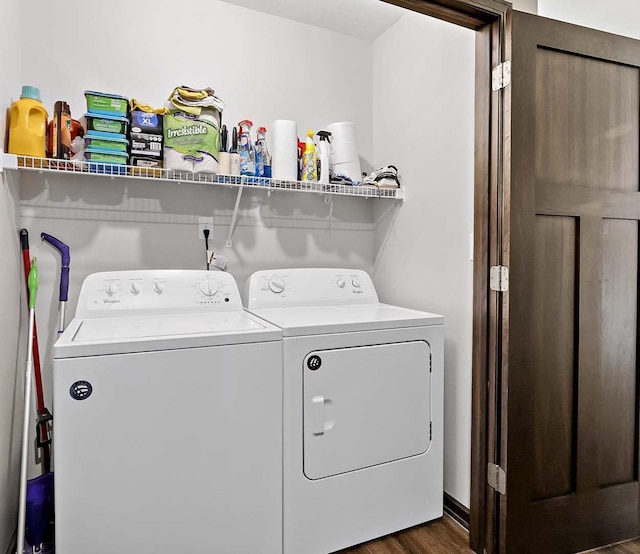 clothes washing area with laundry area, dark wood-style flooring, and washing machine and clothes dryer