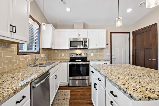 kitchen with dark wood finished floors, white cabinetry, stainless steel appliances, and a sink