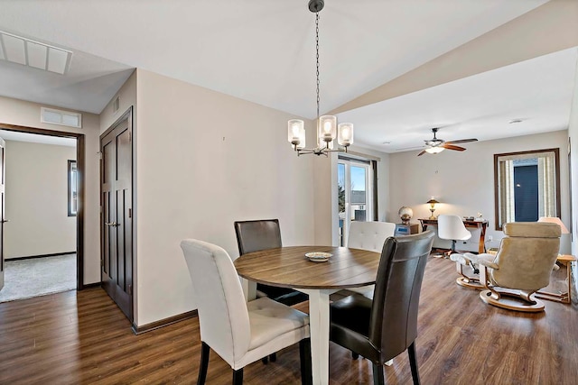 dining room featuring dark wood-style flooring, baseboards, visible vents, ceiling fan with notable chandelier, and lofted ceiling