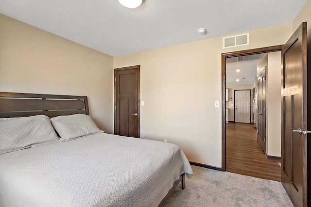 carpeted bedroom with baseboards and visible vents