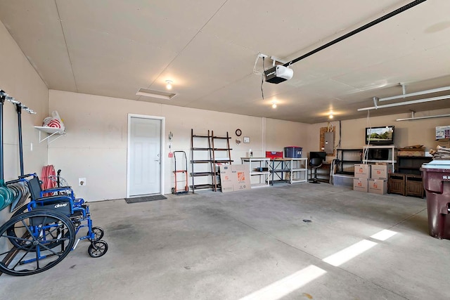 garage with electric panel and a garage door opener
