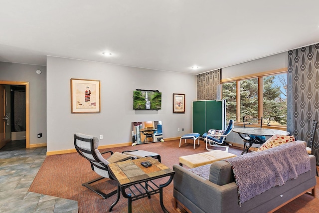 living room with stone finish floor, recessed lighting, and baseboards