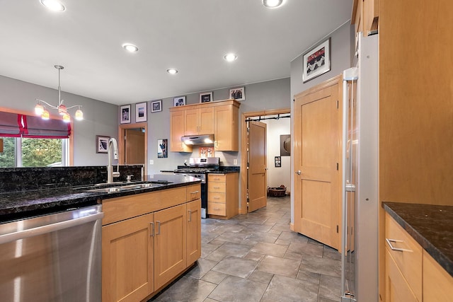 kitchen featuring under cabinet range hood, light brown cabinetry, recessed lighting, stainless steel appliances, and a sink