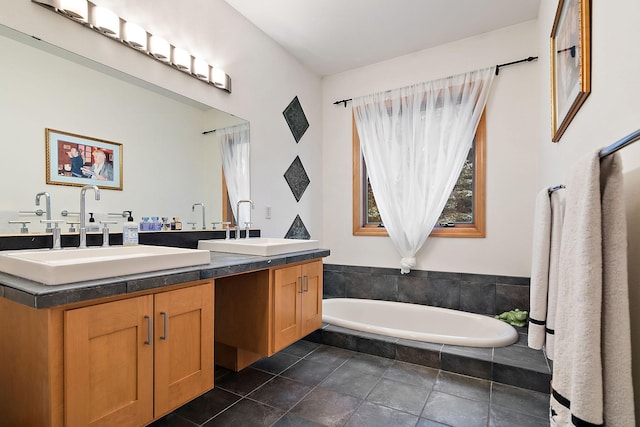 bathroom featuring double vanity, a garden tub, and a sink