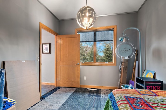 bedroom featuring an inviting chandelier, crown molding, and baseboards