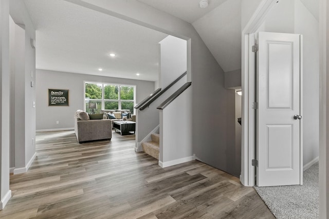 foyer featuring stairs, recessed lighting, baseboards, and wood finished floors