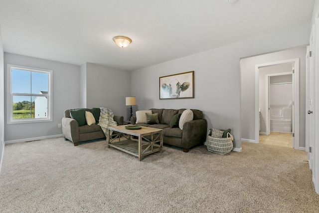 living room with carpet and baseboards