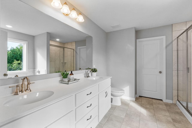 full bath with double vanity, a sink, toilet, and a shower stall