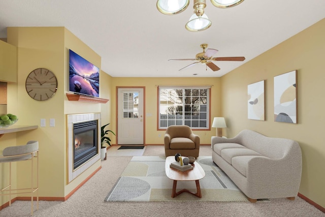 living area with carpet floors, baseboards, and a tile fireplace