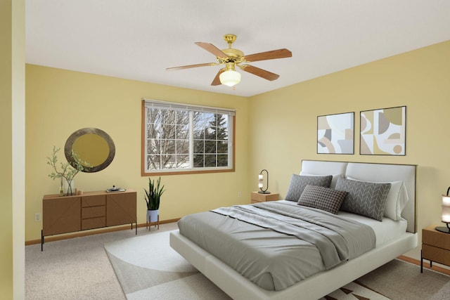 bedroom with a ceiling fan, carpet, and baseboards