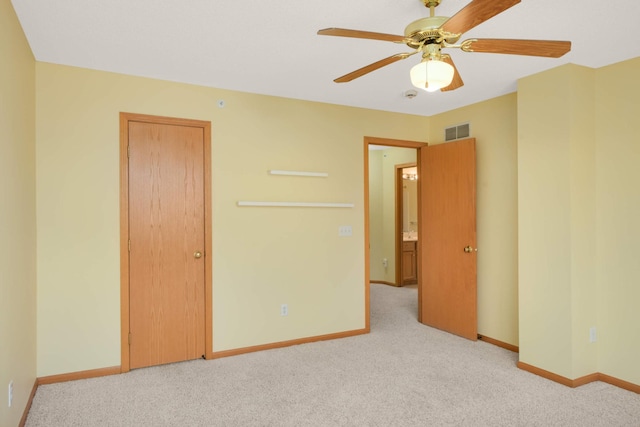 unfurnished bedroom with baseboards, visible vents, ceiling fan, and carpet flooring