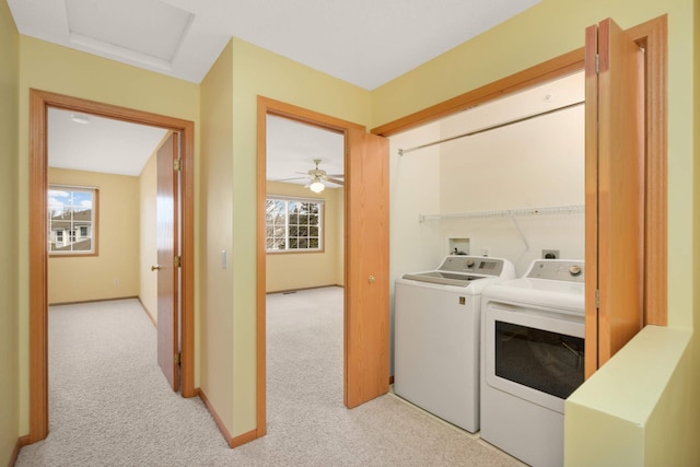 laundry area with washing machine and clothes dryer, attic access, light carpet, laundry area, and baseboards