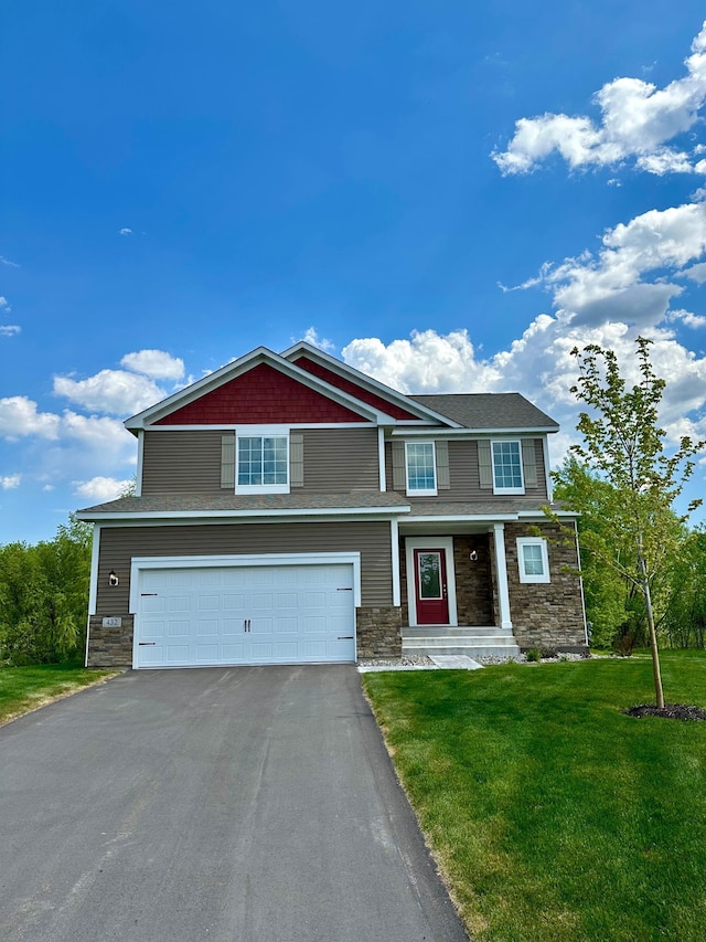 view of front of property with aphalt driveway, a front yard, stone siding, and a garage