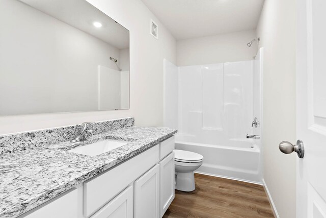432 Wildflower Ct, Waverly, MN 55390 - bathroom featuring vanity, wood finished floors, washtub / shower combination, and recessed lighting