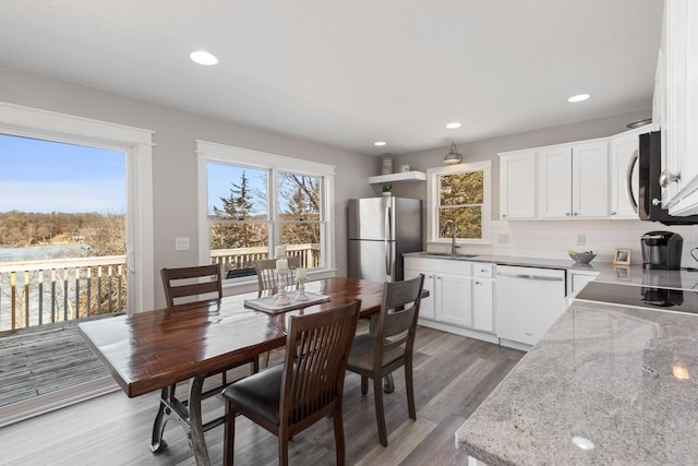 dining area featuring recessed lighting and light wood finished floors