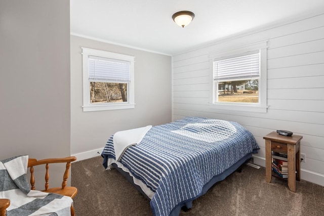 carpeted bedroom featuring baseboards