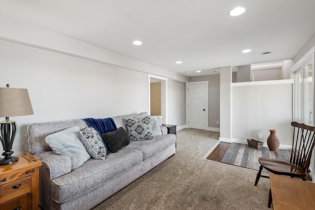 carpeted living area featuring recessed lighting and baseboards