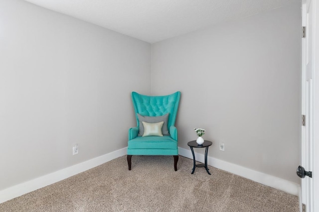 living area with baseboards and carpet floors