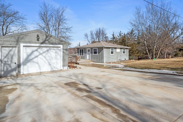 view of front of property with an outbuilding, driveway, a garage, and board and batten siding