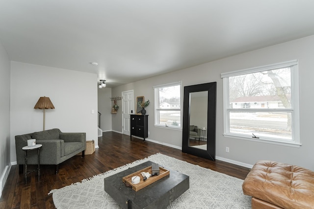 living area with baseboards and wood finished floors