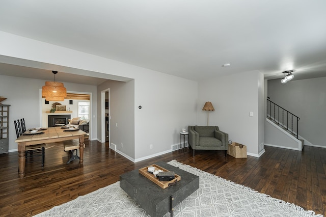 living room with stairway, baseboards, and hardwood / wood-style floors