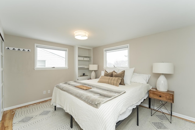 bedroom featuring baseboards and wood finished floors