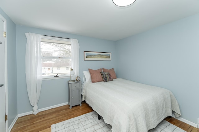 bedroom featuring wood finished floors and baseboards