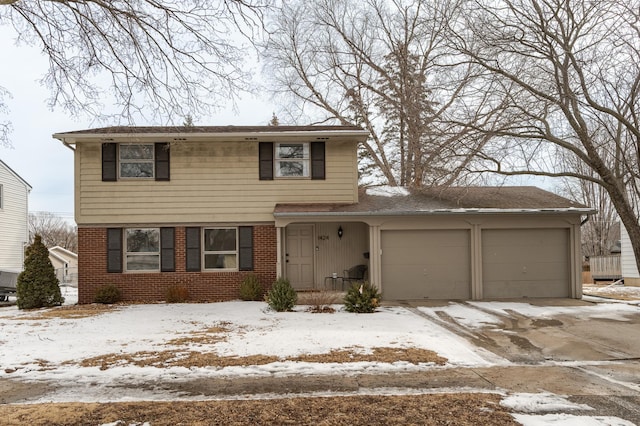 traditional-style house with a garage, brick siding, and driveway