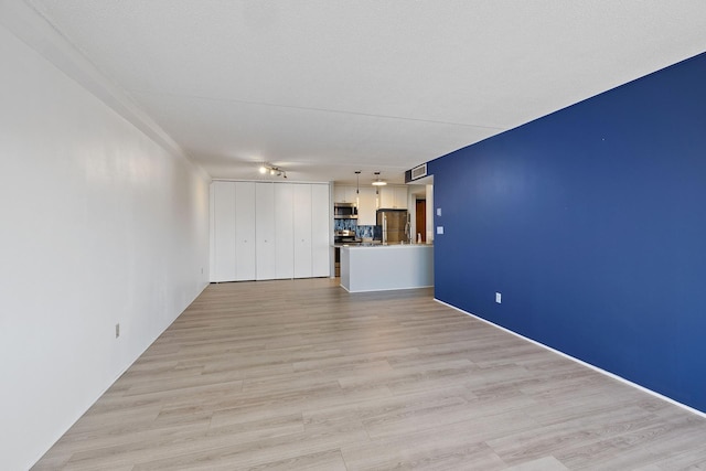 unfurnished living room with light wood-type flooring