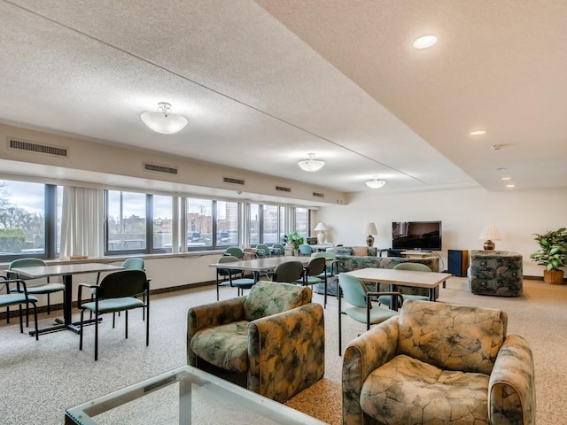 living room featuring visible vents, baseboards, and a textured ceiling